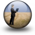 Man on laptop in field